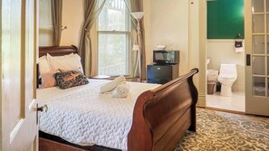 Our snug queen bedroom invites you to cozy up and embrace relaxation at its finest.