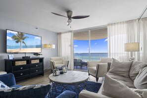 The spacious living area seamlessly connects the kitchen and the balcony