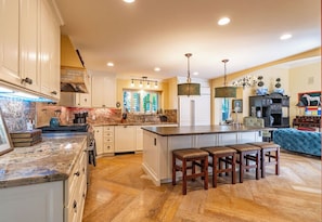 Savor the joy of cooking in our gourmet kitchen while remaining close to family in the adjacent family room, ensuring every meal is a shared experience filled with warmth and laughter.