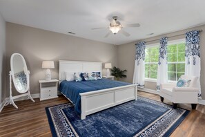 [Master Bedroom] King bed facing wall-mounted Roku TV; master bath to the left.