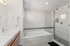 Primary Bathroom with rainfall shower, tub and double vanity