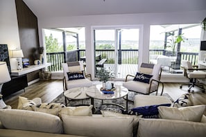 A comfortable array of furnishings invites relaxation and gatherings. Accent pillows in shades of blue echo the colors of the lake.