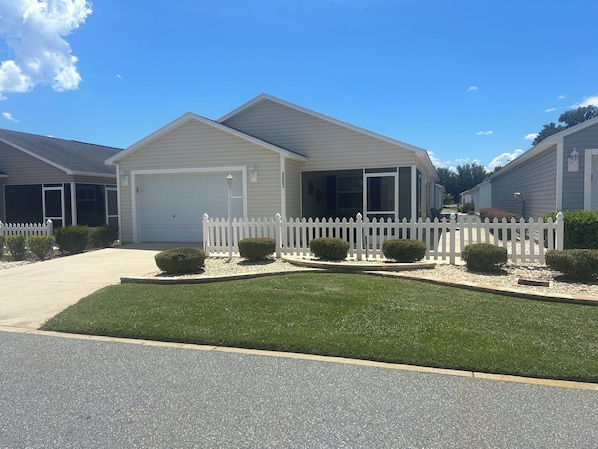 Front of house with private  driveway and a 1 1/2 car garage