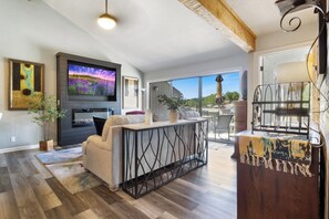 Elegant retreat boasts a cozy fireplace and an expansive 65-inch smart TV.