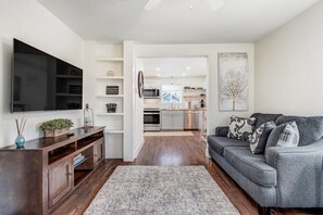 Sink into the plush sofa, catch up on your favorite shows on the smart TV, and bask in the natural light filtering through.