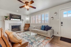 Gather the whole gang in our spacious living room, complete with plush couches, a crackling fireplace, and a smart TV for movie nights that'll make everyone feel right at home.
