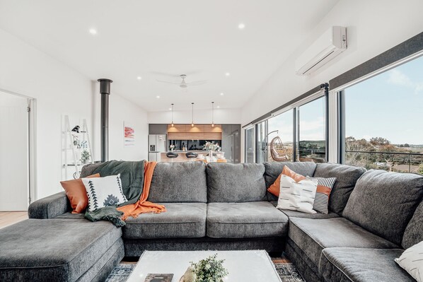 Relax with a book or a glass of wine on this cozy couch, all while enjoying the stunning backdrop!