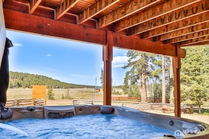 Relax and unwind in the cabin's hot tub, perfect for a soothing evening after a day of adventure or simply for enjoying the serene surroundings.