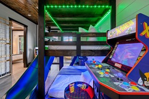 X-Men and Pacman arcades on either side of the 3 full size bunk beds with slide & climbing play wall - the kids will absolutely LOVE it!