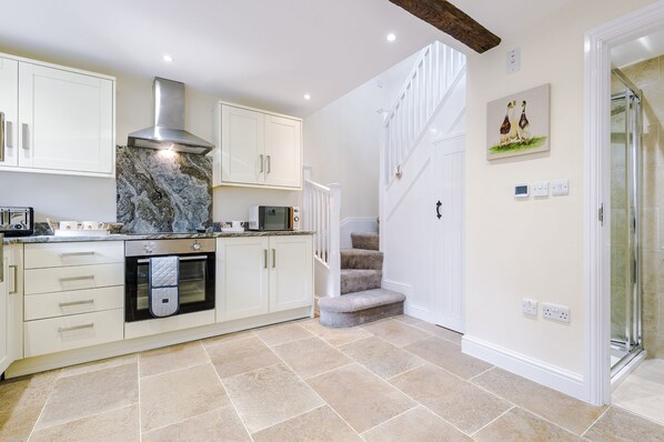 The bright and airy well-equipped kitchen leading to the shower room, and first floor