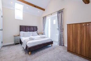 Bedroom two with a door and steps leading down to the enclosed courtyard