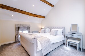Simplistic beauty and exposed beams in bedroom one