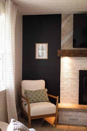 Living Room with comfy couches, fireplace and smart TV