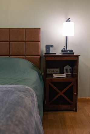 Unwind in a cozy queen bed with phone and watch charger