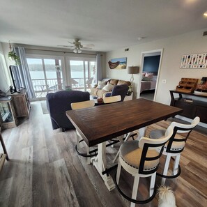 Dining room with 4 chairs.  There are 4 more stools at the bar behind this.