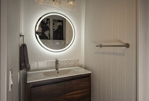 Extra mirror and vanity in hallway.
