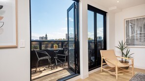 Large glass balcony doors to outdoor seating