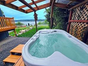 Relax in the hot tub while enjoying panoramic water views