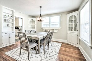 Dining opens up into the living and kitchen. Wine Glasses, placemats, vintage.