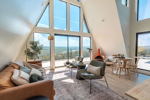Living Room: Experience stunning views and chic design in this light-filled, inviting space!