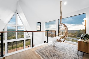 Hanging Retreat: Swing into serenity with panoramic views and chic decor! Perfect for relaxation.
