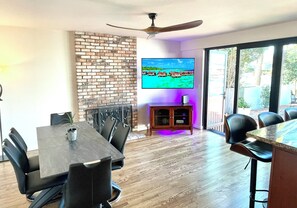 Dining table sits 6 people, smart tv, luxury bifold doors open to backyard