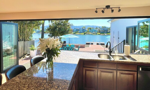 Kitchen - luxury bifold doors & windows completely open up to the backyard