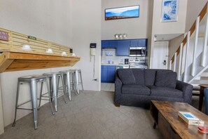 The breakfast bar sits four people.  The twin sofa bed in the living room sleeps one person.