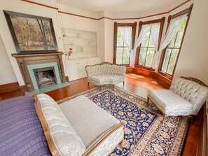 Our living room has a fireplace and floor-to-ceiling windows as well.