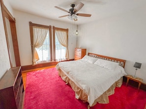 Our bedroom has a king-sized bed and large windows.