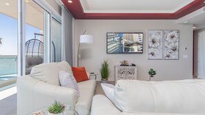 Two leather sofas in the living room by the TV