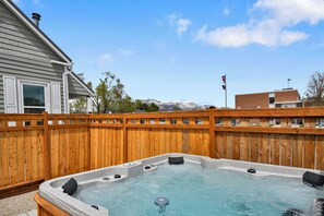 A brand new McKinley Arctic Spa Hot Tub in the fully fenced back yard with view of the Wasatch Back