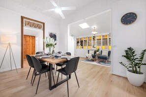 Expansive open living and dining room adorned with sleek modern timber furniture