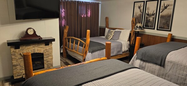 Cedar and Pine Log Beds, Large TV, and Fireplace