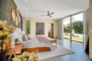 Our KIKAL ('Harmony' in Maya) master bedroom is equipped with King sized bed with memory foam mattress, walk-in-closet, en-suite bathroom with dual vanities, bidet, & outdoor jacuzzi. Sliding glass doors with blackout curtains open to backyard pool!