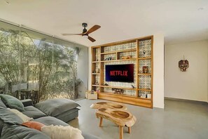 Unwind in the cozy living room featuring a 65" smart TV, high-speed internet, board games, & vibrant Mexican folk art sculptures known as "Alebrijes". Each piece has been collected during travels across Mexico, adding cultural richness to the space..