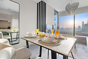 Dining Area: Savor meals with stunning skyline views and elegant decor! Perfect for unforgettable moments.
