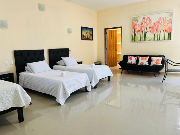Bedroom with double bed, two twin beds and sofa cama