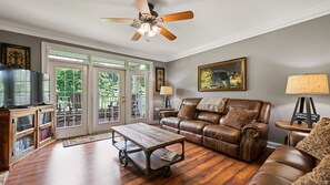 The spacious living room with French doors that lead out to the balcony.