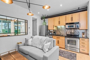 Light-filled kitchen/living/dining area. NOTE: the couch bed pulls out into a comfortable full-sized bed.