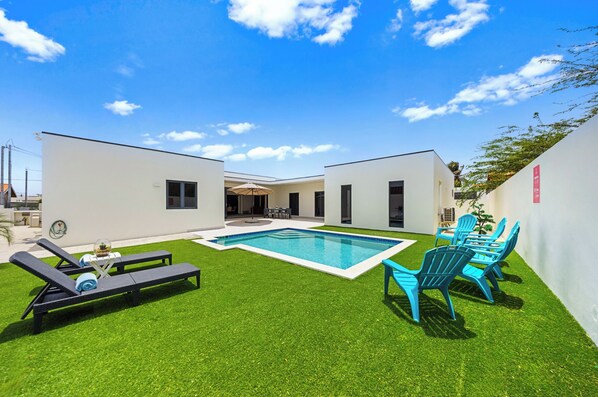 Refreshing private pool area of the home in Noord, Aruba - Enjoy the convenience of fresh water throughout the stay - Availability of cozy beach chairs and fresh towels - Indulge in the views of lush surroundings