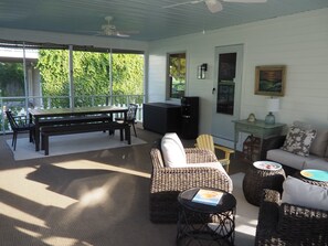 Spacious front porch with living, dining and play space 