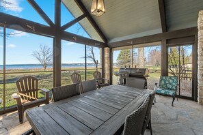 Glassed-in patio has a combo charcoal/ propane grill