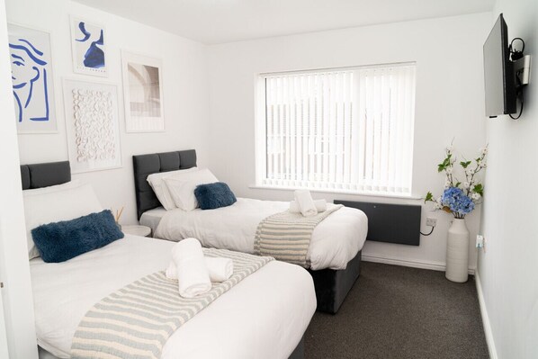 Bedroom 1 has a Smart TV and a comfortable zip-link bed which is configured as two single beds by default or can be zipped together to form a king size bed upon request.