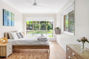 The second bedroom highlights a queen-sized bed bathed in plenty of natural light.
