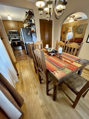 This inviting dining room features a beautiful wooden table, comfortable chairs, and warm natural light.