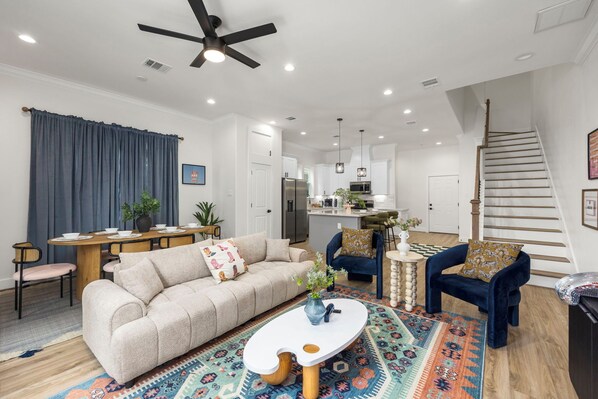 Cozy living room with ceiling fan and the dining area at the back