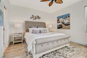 Master bedroom with king size bed, ensuite bathroom, TV and ample closet space. There is also access to the pool deck.
