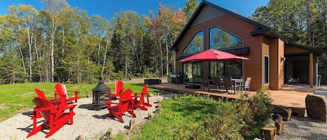 Sunny days and red chairs await! Relax on the deck.