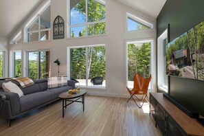 Sun-drenched living with forest views.